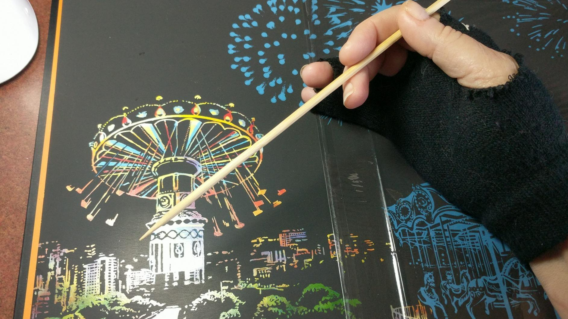 A customer photo of their finished scratch art