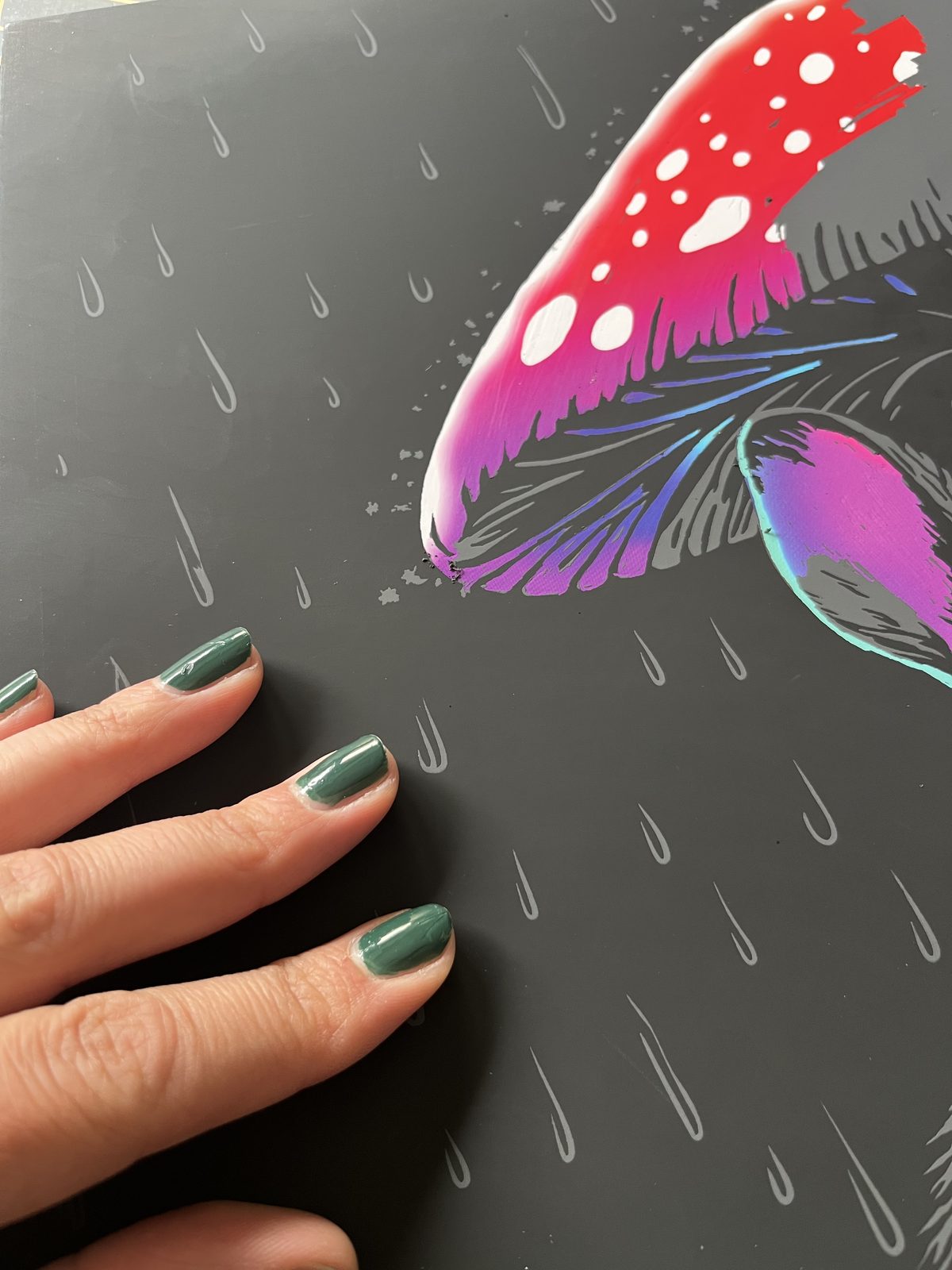 A hand scratching grey lines on a Gatsby Canvas — color revealing underneath